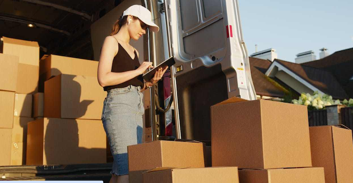 Woman who is moving keeps track of each box that she loads